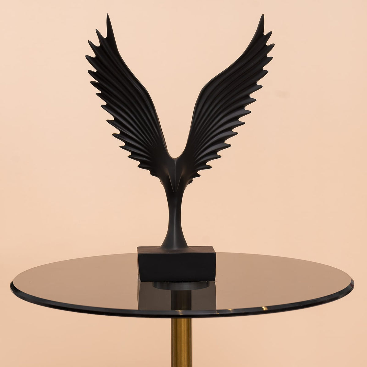 modern black and silver resin eagle wing sculpture mounted on a rectangular base