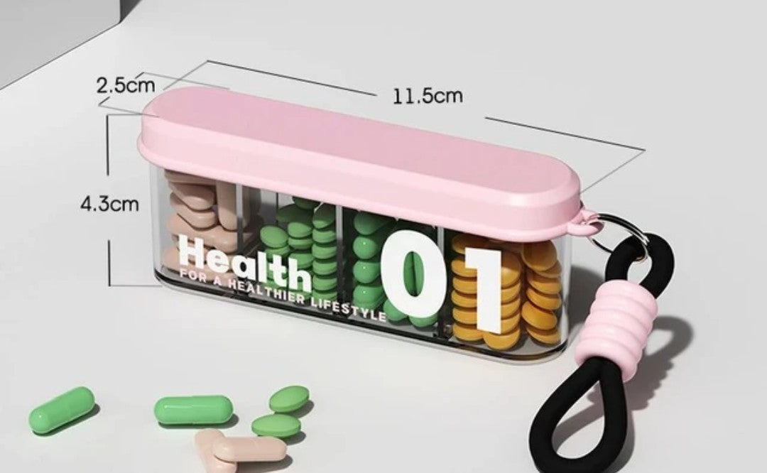 Portable travel pill organizer with four compartments and a carrying strap.