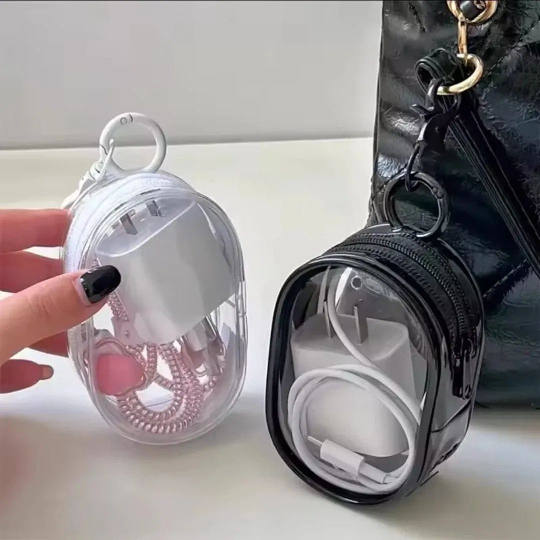 Portable mini transparent zipper pouch with a keychain, designed in an oval shape to neatly organize a phone charger and coiled cable